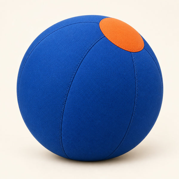 Blue fabric-covered herding ball with an orange detail